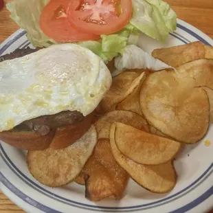 My Sunshine Burger; burger topped with lettuce, tomato, pickles and a lovely gooey messy egg. Oh and a side of home made chips!