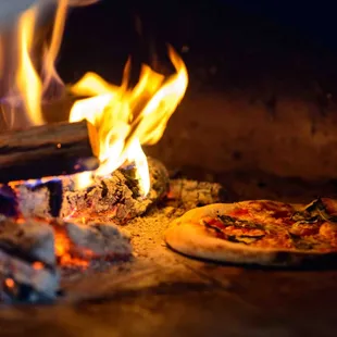 two pizzas being cooked