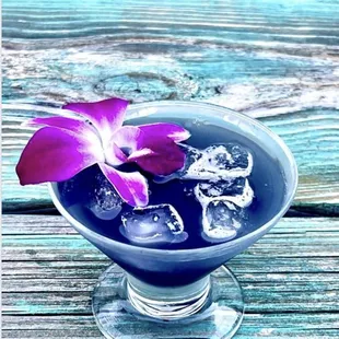 a purple flower and ice cubes