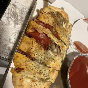 Pepperoni and mushroom calzone with marinara