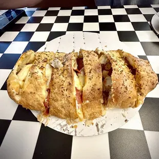 Calzone with pepperoni and grilled chicken.