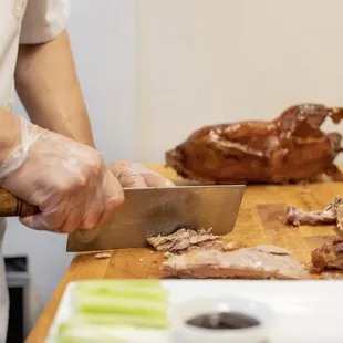 a chef slicing meat on a cutting board