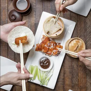 a plate of food being served with chopsticks