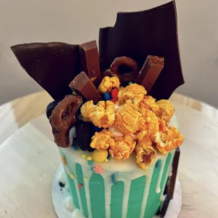 a cake decorated with popcorn and chocolate