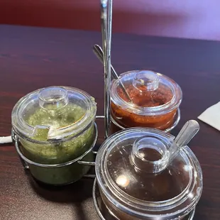 three condiments on a table