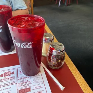 two glasses of soda on a table