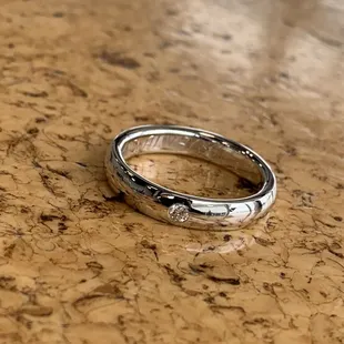 Silver gypsy set diamond band with special inside ring engraving. Made and designed in a Oklahoma by Journey Jewelers.