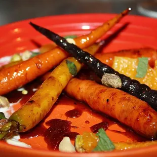 The Oak Ember Roasted Rainbow Carrots was made with Carrot Butterscotch, Crunchy Seeds, Whipped Feta, Citrus, &amp; Torn Mint.