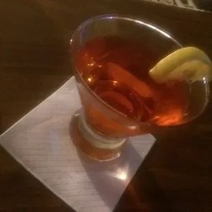 a glass of tea with a lemon wedge