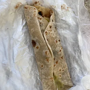 a tortilla wrapped in wax paper