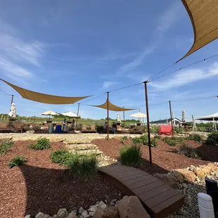 a picnic area with tables and umbrellas
