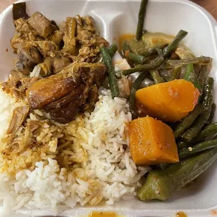 Plate with rice, chicken adobo and pinakbet