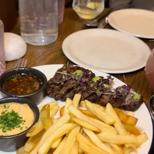 a plate of french fries and steak