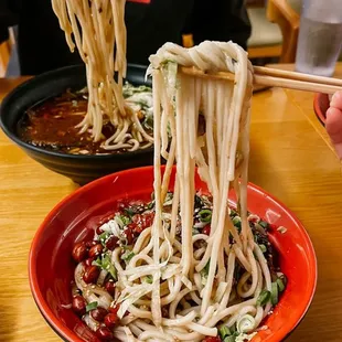 a man eating noodles