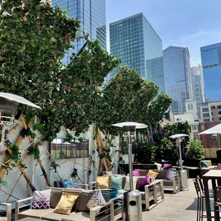 a patio with tables, chairs, and umbrellas