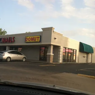 Right on the corner of a strip mall containing Little Caesars and a nail salon.