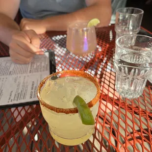 a person sitting at a table with a drink