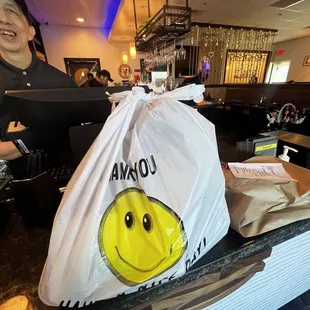 a bag with a smiley face on it