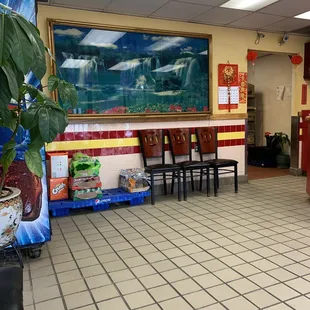 a restaurant with a large painting on the wall