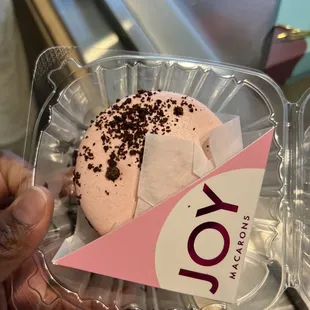 a hand holding a cupcake