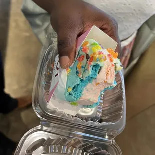 a person holding a piece of cake