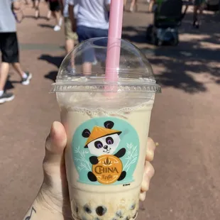 a hand holding a cup of bubble tea