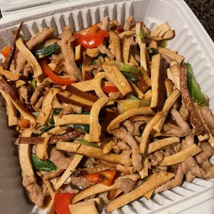 a takeout container of chicken and vegetables