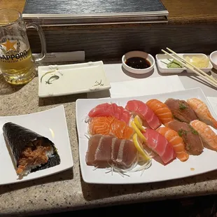 a plate of sushi and a glass of beer