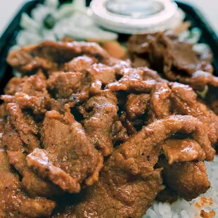 beef and rice in a black container