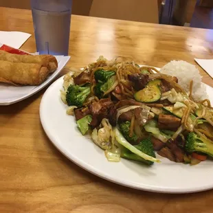 yakisoba with chicken and egg rolls.