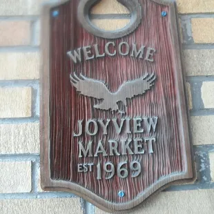 a sign on a brick wall