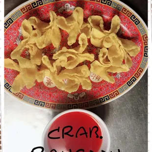 a plate of noodles and a bowl of sauce