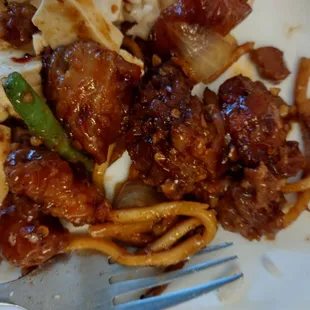 a plate of food with noodles and meat