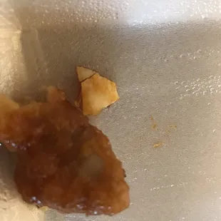 egg shell that was on piece of orange chicken.
