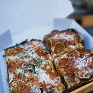 four slices of pizza in a box