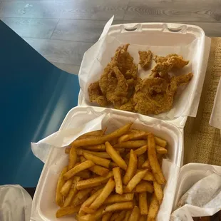 chicken and fries in a styrofoam container