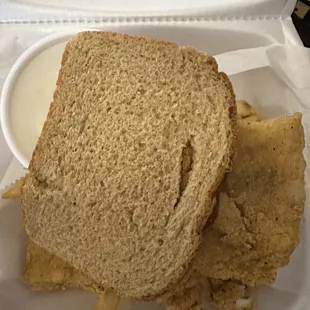 a sandwich and chips in a styrofoam container