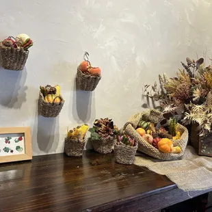 baskets of fruit and flowers on a table