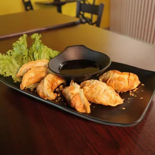 a plate of food with dipping sauce