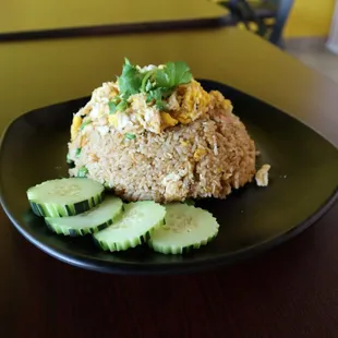 a plate of rice and cucumbers