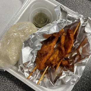Chicken on a stick w/ sticky rice and chili paste :)