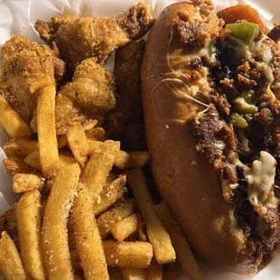 Cheesesteak, lemon pepper wings and fries.
