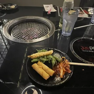 Kimchi, spring rolls, edamame and tempura shrimp from the bar