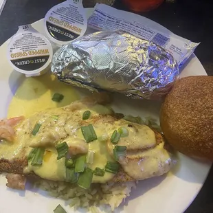 Grilled Red Fish topped with a lobster crawfish cream sauce, baked potato and a roll. Excellent choice