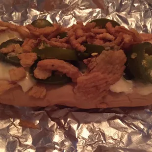 Hot dog with cheese sauce, jalapeños and fried onion rings.