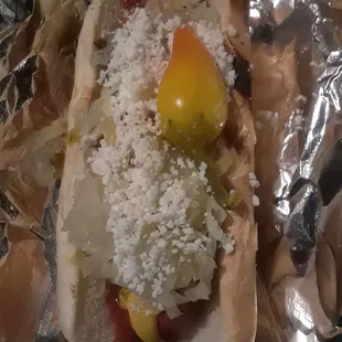 a hot dog covered in condiments