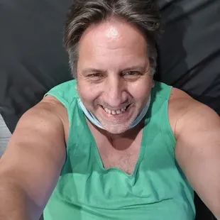 a man in a green shirt with a collar around his neck