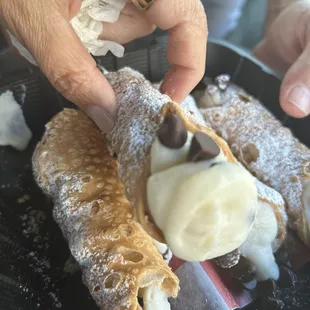 Looks can be deceiving-this Cannoli wasn't filled all the way. Look at the other picture. 7/2 Take out order.