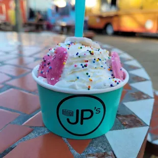 a cup of ice cream with sprinkles