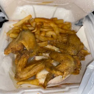 chicken and fries in a styrofoam container